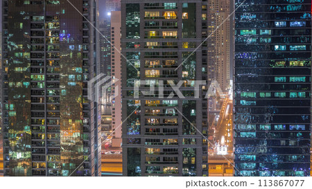 Residential and office buildings in Jumeirah lake towers district night timelapse in Dubai 113867077