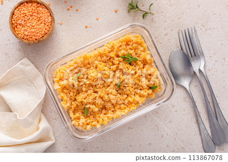 Cooked red lentils in a meal prep container, healthy vegan protein source 113867078