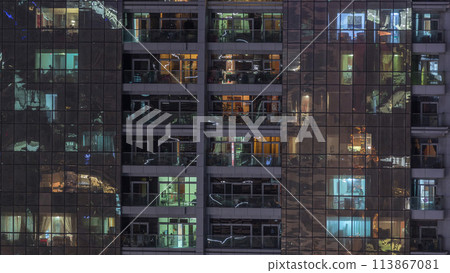 Night view of exterior apartment building timelapse. High rise skyscraper with blinking lights in windows Night view of exterior apartment building timelapse. High rise skyscraper with blinking lights in windows 113867081