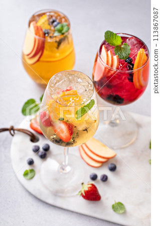 Refreshing summer sangria with berries and fruits with red and white wine Refreshing summer sangria with berries and fruits with red and white wine 113867087