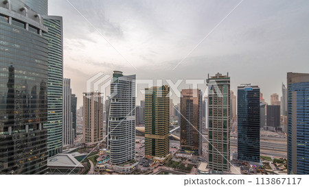 Residential and office buildings in Jumeirah lake towers district day to night timelapse in Dubai Residential and office buildings in Jumeirah lake towers district day to night timelapse in Dubai 113867117