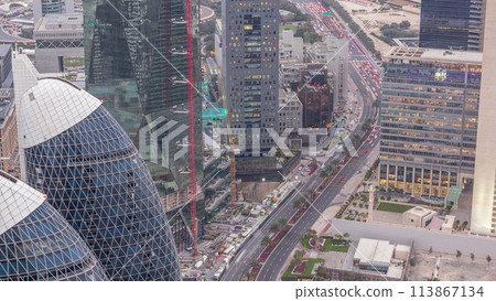 Skyline of the buildings of Sheikh Zayed Road and DIFC aerial day to night timelapse in Dubai, UAE. Skyline of the buildings of Sheikh Zayed Road and DIFC aerial day to night timelapse in Dubai, UAE. 113867134