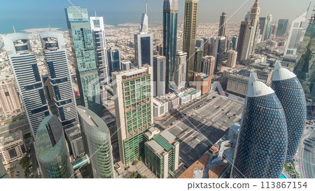 Skyline view of the buildings of Sheikh Zayed Road and DIFC aerial timelapse in Dubai, UAE. 113867154