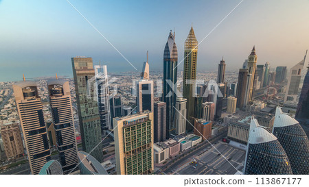 Skyline view of the buildings of Sheikh Zayed Road and DIFC aerial timelapse in Dubai, UAE. Skyline view of the buildings of Sheikh Zayed Road and DIFC aerial timelapse in Dubai, UAE. 113867177