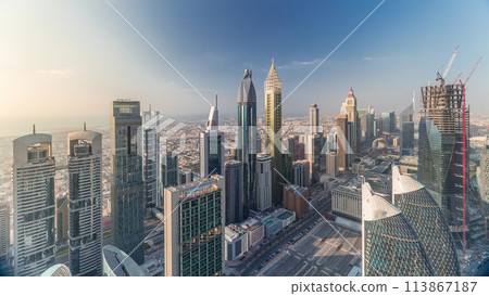 Skyline view of the buildings of Sheikh Zayed Road and DIFC aerial timelapse in Dubai, UAE. 113867187