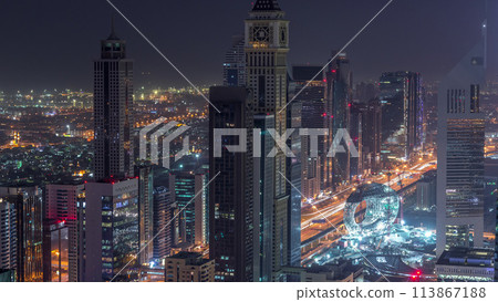 Skyline of the buildings of Sheikh Zayed Road and DIFC aerial night to day timelapse in Dubai, UAE. 113867188