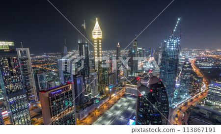 Skyline of the buildings of Sheikh Zayed Road and DIFC aerial night timelapse in Dubai, UAE. 113867191