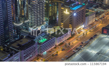 Car parking lot with rooftop swimming pool viewed from above night timelapse, Aerial top view. Dubai, UAE 113867194