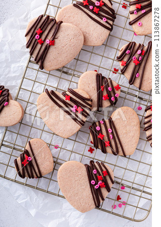 Heart shaped cookies with strawberry flavor, drizzled with dark chocolate Heart shaped cookies with strawberry flavor, drizzled with dark chocolate 113867278