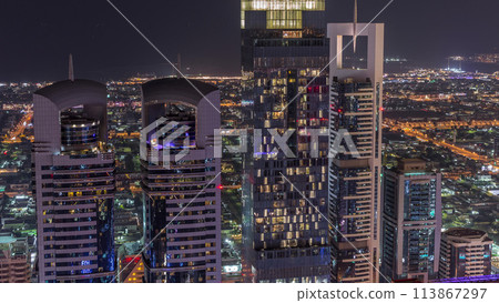 Skyline of the buildings of Sheikh Zayed Road and DIFC aerial night timelapse in Dubai, UAE. 113867297