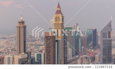 Skyline of the buildings of Sheikh Zayed Road and DIFC aerial day to night timelapse in Dubai, UAE. Skyline of the buildings of Sheikh Zayed Road and DIFC aerial day to night timelapse in Dubai, UAE. 113867318