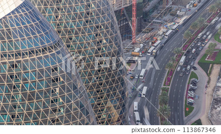 Skyline view of intersection traffic on Al Saada street near DIFC timelapse in Dubai, UAE. Skyline view of intersection traffic on Al Saada street near DIFC timelapse in Dubai, UAE. 113867346