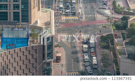 Aerial view of a road intersection in a big city timelapse. Aerial view of a road intersection in a big city timelapse. 113867391