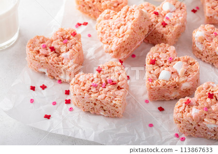 Pink heart shaped rice krispie treats served with milk 113867633