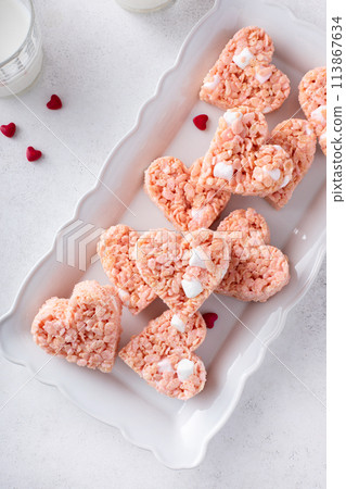 Pink heart shaped rice krispie treats served with milk 113867634