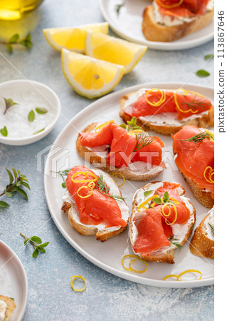Smoked salmon crostini with cream cheese, dill and lemon zest Smoked salmon crostini with cream cheese, dill and lemon zest 113867646