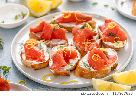 Smoked salmon crostini with cream cheese, dill and lemon zest 113867656