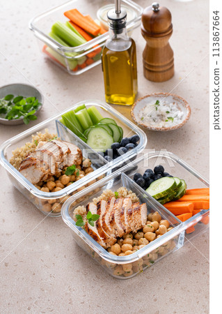 High protein healthy lunch meal prep in containers with chicken, quinoa, herbed chickpeas, vegetables and eggs High protein healthy lunch meal prep in containers with chicken, quinoa, herbed chickpeas, vegetables and eggs 113867664