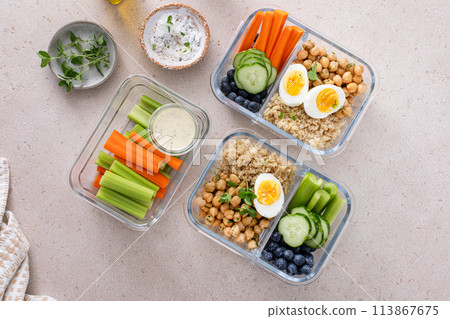 Vegetarian lunch meal prep containers high protein with quinoa, herbed chickpeas, vegetables and eggs 113867675