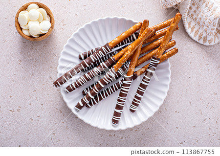 Chocolate dipped pretzel rods on a plate Chocolate dipped pretzel rods on a plate 113867755