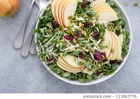 Healthy kale and cabbage mix salad with apples and pumpkin seeds 113867776