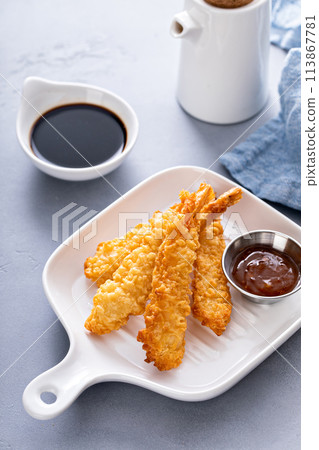 Cooked tempura shrimp on a plate with dipping sauce 113867781