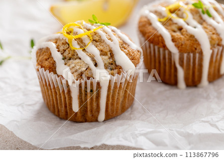 Lemon zucchini muffins drizzled with sugar glaze 113867796