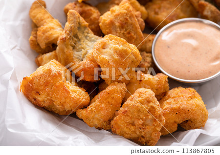 Catfish nuggets in a bowl with dipping sauce Catfish nuggets in a bowl with dipping sauce 113867805