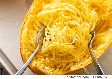 Spaghetti squash baked and pulled apart ready to eat on a baking pan Spaghetti squash baked and pulled apart ready to eat on a baking pan 113867876