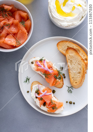 Making salmon crostini or bruschetta with smoked salmon 113867880