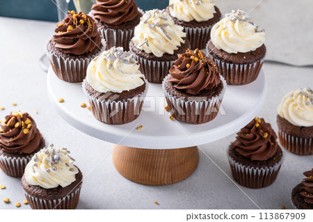 New Years Eve party cupcakes with vanilla and chocolate frosting and festive sprinkles New Years Eve party cupcakes with vanilla and chocolate frosting and festive sprinkles 113867909