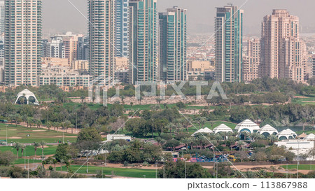 Dubai Golf Course with a cityscape of Greens and tecom districts at the background aerial timelapse Dubai Golf Course with a cityscape of Greens and tecom districts at the background aerial timelapse 113867988