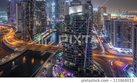 Aerial view of Dubai Marina residential and office skyscrapers with waterfront night timelapse 113868013