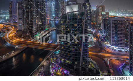 Aerial view of Dubai Marina residential and office skyscrapers with waterfront night timelapse 113868014