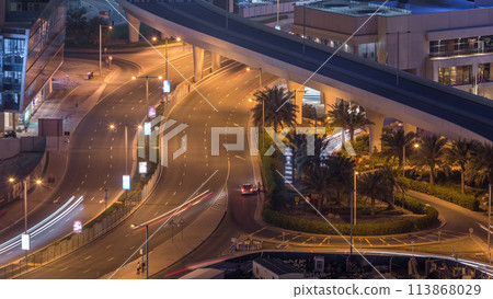 Aerial view to Dubai marina street with construction site on background night timelapse. Aerial view to Dubai marina street with construction site on background night timelapse. 113868029