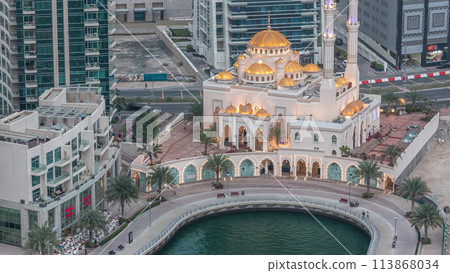 Modern residential architecture of Dubai Marina and Mohammed Bin Ahmed Almulla Mosque aerial day to night timelapse 113868034