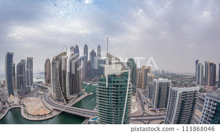 Aerial view of Dubai Marina residential and office skyscrapers with waterfront day to night timelapse 113868046