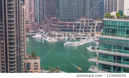 Aerial view of Dubai Marina residential and office skyscrapers with waterfront day to night timelapse 113868050