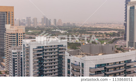 Dubai Golf Course with a cityscape of Greens and tecom districts at the background aerial timelapse Dubai Golf Course with a cityscape of Greens and tecom districts at the background aerial timelapse 113868051