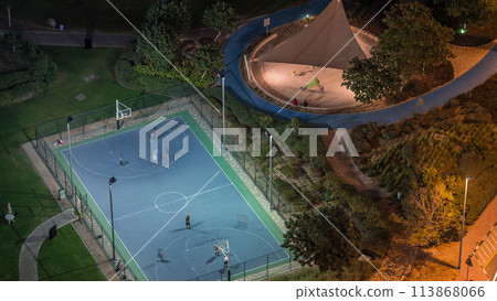 Basketball court at park in Jumeirah Lakes Towers district timelapse, a popular residential district in Dubai. Basketball court at park in Jumeirah Lakes Towers district timelapse, a popular residential district in Dubai. 113868066