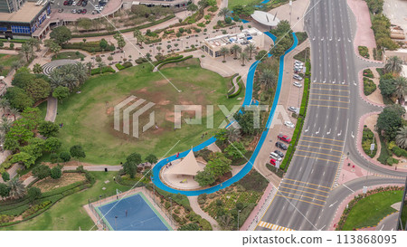 A landscaped public park in Jumeirah Lakes Towers timelapse, a popular residential district in Dubai. A landscaped public park in Jumeirah Lakes Towers timelapse, a popular residential district in Dubai. 113868095