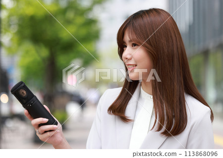 Young female interviewer interviewing people on the street 1 Young female interviewer interviewing people on the street 1 113868096