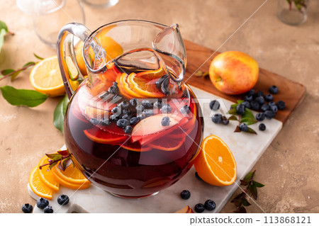 Winter orange and berry sangria with sliced oranges and blueberries 113868121