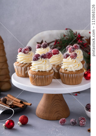 Spiced cinnamon and cranberry cupcakes topped with sugared cranberries for Christmas or Thanksgiving 113868126