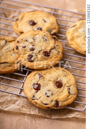 Chocolate chip cookies freshly baked on parchment paper 113868162