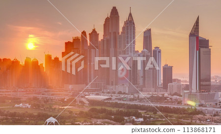 Dubai Marina skyscrapers and golf course sunset timelapse, Dubai, United Arab Emirates Dubai Marina skyscrapers and golf course sunset timelapse, Dubai, United Arab Emirates 113868171