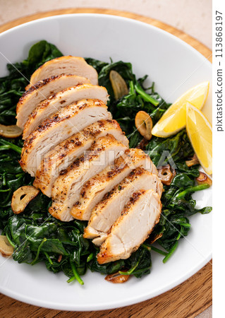 Grilled chicken breast with sauteed garlic spinach, healthy lunch idea Grilled chicken breast with sauteed garlic spinach, healthy lunch idea 113868197