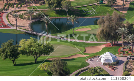 Landscape of green golf course with trees aerial timelapse. Dubai, UAE Landscape of green golf course with trees aerial timelapse. Dubai, UAE 113868204