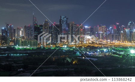 Jumeirah lake towers and Dubai marina skyscrapers and golf course during all night timelapse, Dubai, United Arab Emirates 113868242