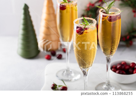 Apple cider mimosa cocktail with cranberries for Christmas 113868255
